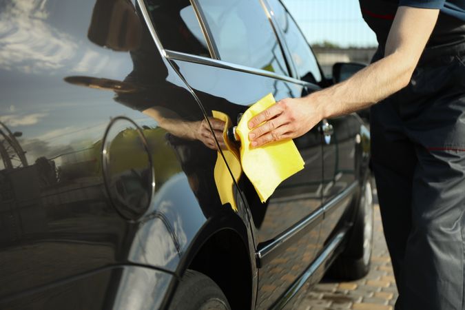 A man rubs a car. Car wash. Clear car concept