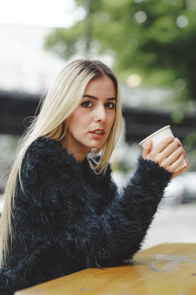 woman drinking coffee in street cafe