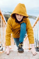 Woman posing on steps near sea