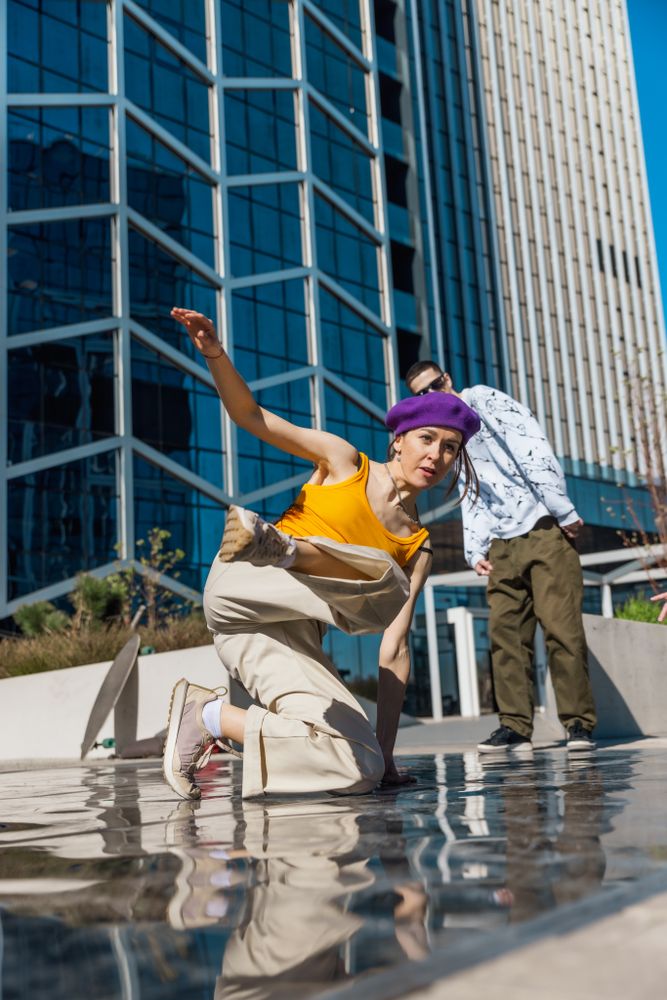 Vertical Screen: Young And Stylish Female Hip-Hop Dancer Freestyling On Street In the Circle Of Fashionable Friends.