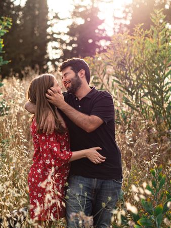 Young happy couple embracing in beautiful garden