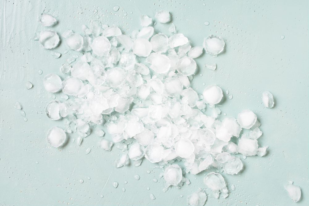 Scattered crushed ice on baby blue background