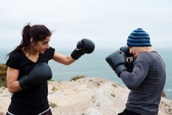 Boxers exercising on cliff