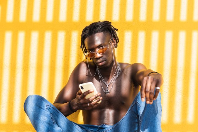 Black hipster guy using smartphone