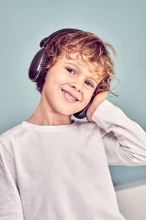 Smiling boy listening to music in headphones