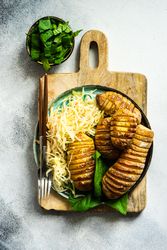 Baked potato, spinach and cabbage salad on marble counter with copy space