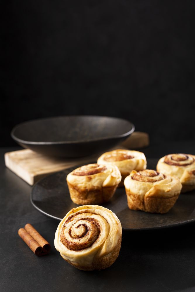 Cinnamon rolls on dark background.