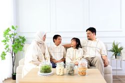 Family Sitting at Living Room Wearing Baju Lebaran Couple