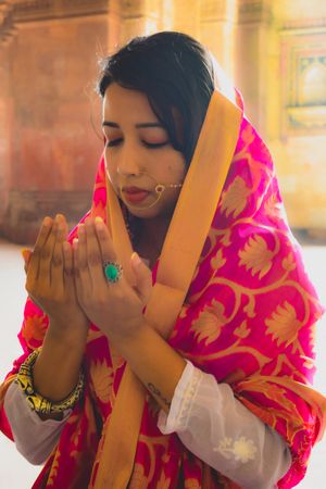 Portrait of Indian woman wearing saree praying