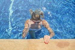 Woman in bikini in swimming pool alone