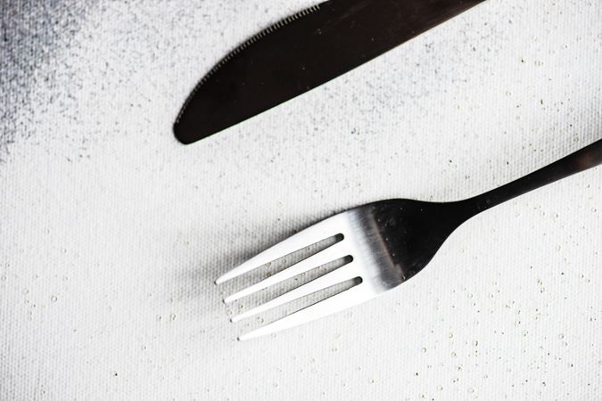 Top view of cutlery set on concrete background