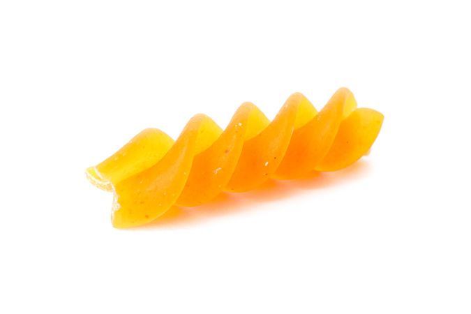 Pasta isolated on bright background, closeup. Dry raw whole pasta