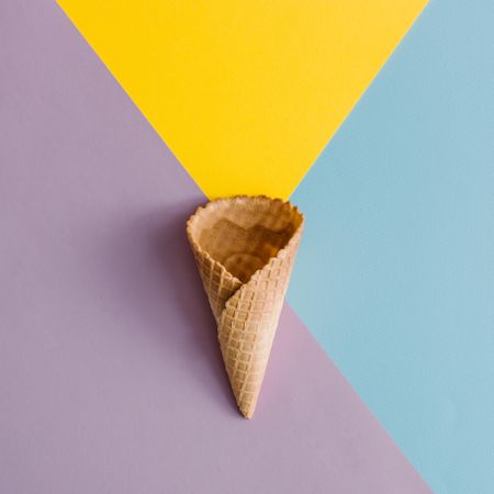 Waffle cone on colorful pastel background