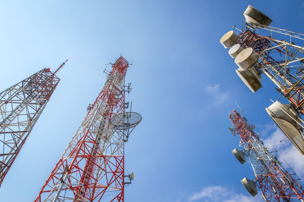 Telecommunication Towers Against a Clear Blue Sky Showing Modern Connectivity Equipment