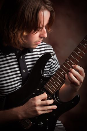 Young Musician Plays His Electric Guitar