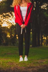 Crop sportive woman standing on meadow