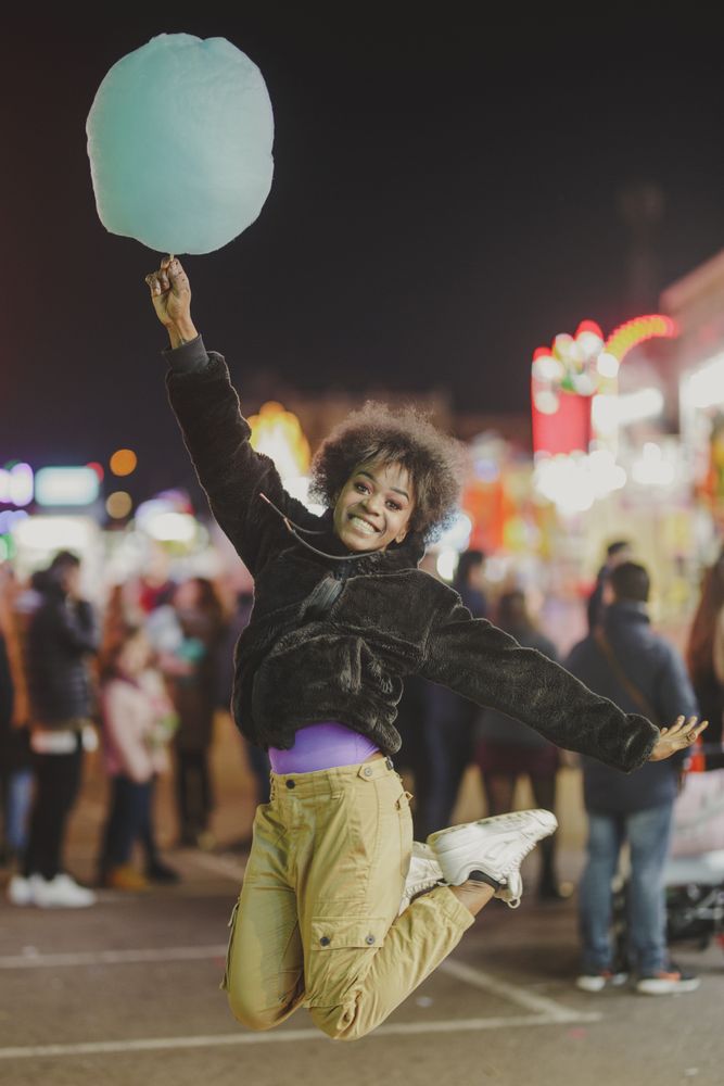 Cheerful Black woman with candy floss