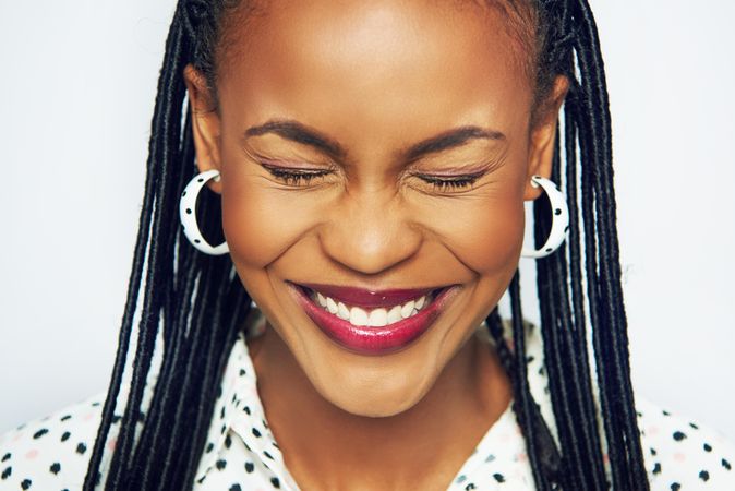 Portrait of happy and fashionable woman with her eyes closed