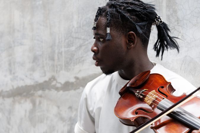 Black male playing on violin.