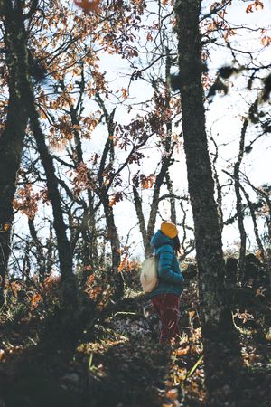 Woman walking in autumn forest