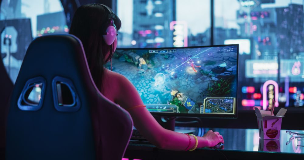 Young Female Gamer Playing Online Multiplayer Battle Arena Video Game on a Computer in a Cyberpunk Digital Neon Studio