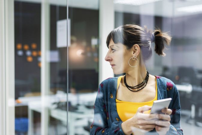 Woman browsing smartphone in office