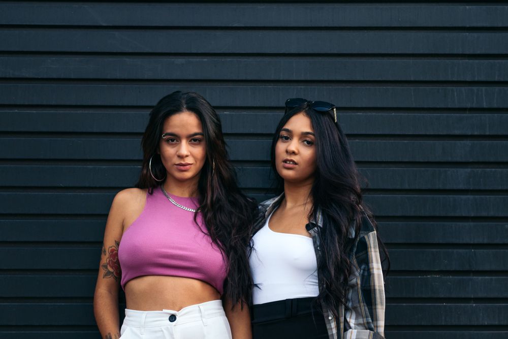 Portrait of two serious latina women