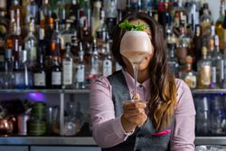 Bartender holding a glass of alcoholic beverage