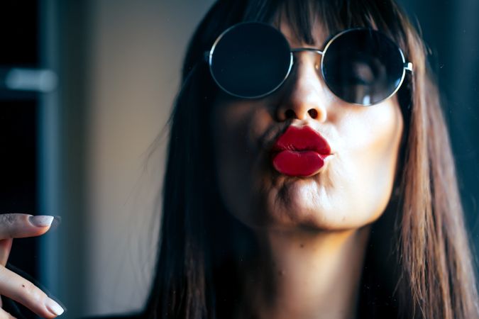 Stylish woman kissing glass
