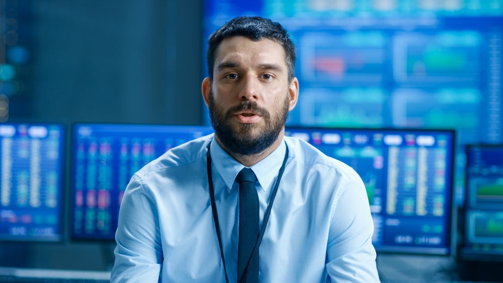 Professional Stock Market Trader Charismatically Talks into the Camera.