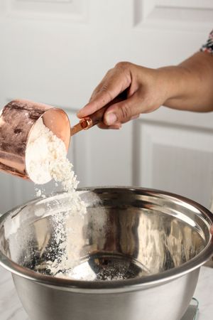 Baking Concept Pouring Flour to Stainless Mixing Bowl
