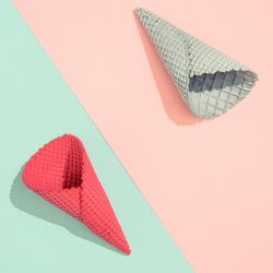Ice cream cones on pastel pink and blue background