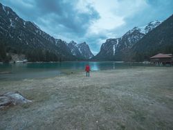 Male photographer near mountains and lake