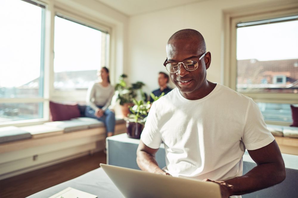 Man working on his laptop in a bright modern office