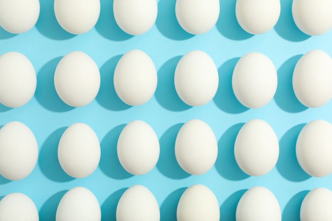 Flat lay composition with chicken eggs on color background, space for text