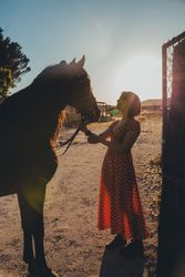 Young woman with horse on ranch