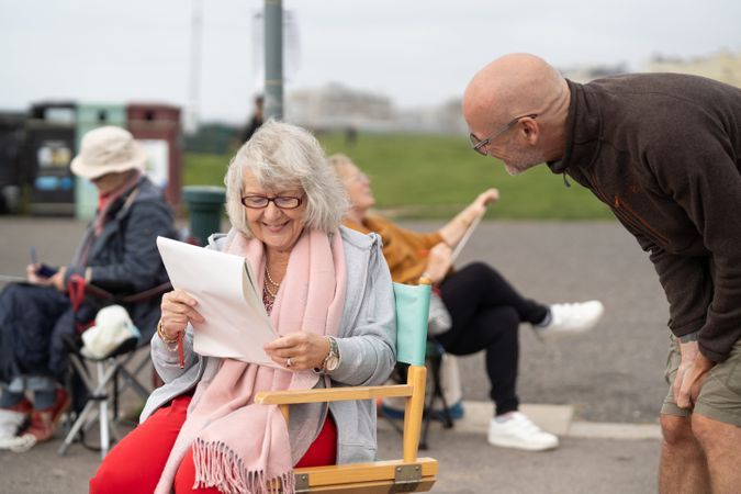 Smiling older woman talking with art instructor
