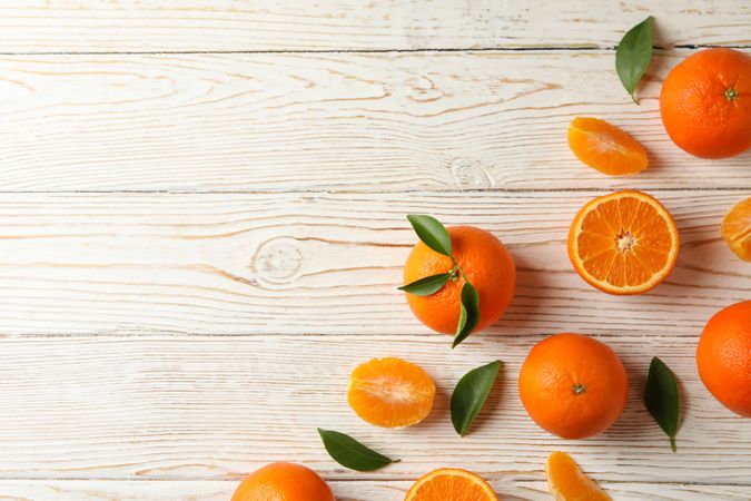 Ripe sweet mandarins on wooden background, top view