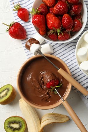 Composition with strawberry and marshmallow in chocolate, top view. Chocolate fondue