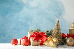 Presents and Christmas tree on decorated background, space for text