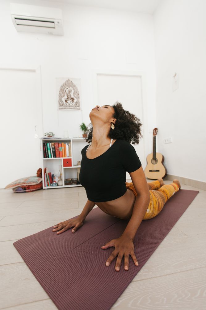 Sportive woman standing in yoga pose with head down