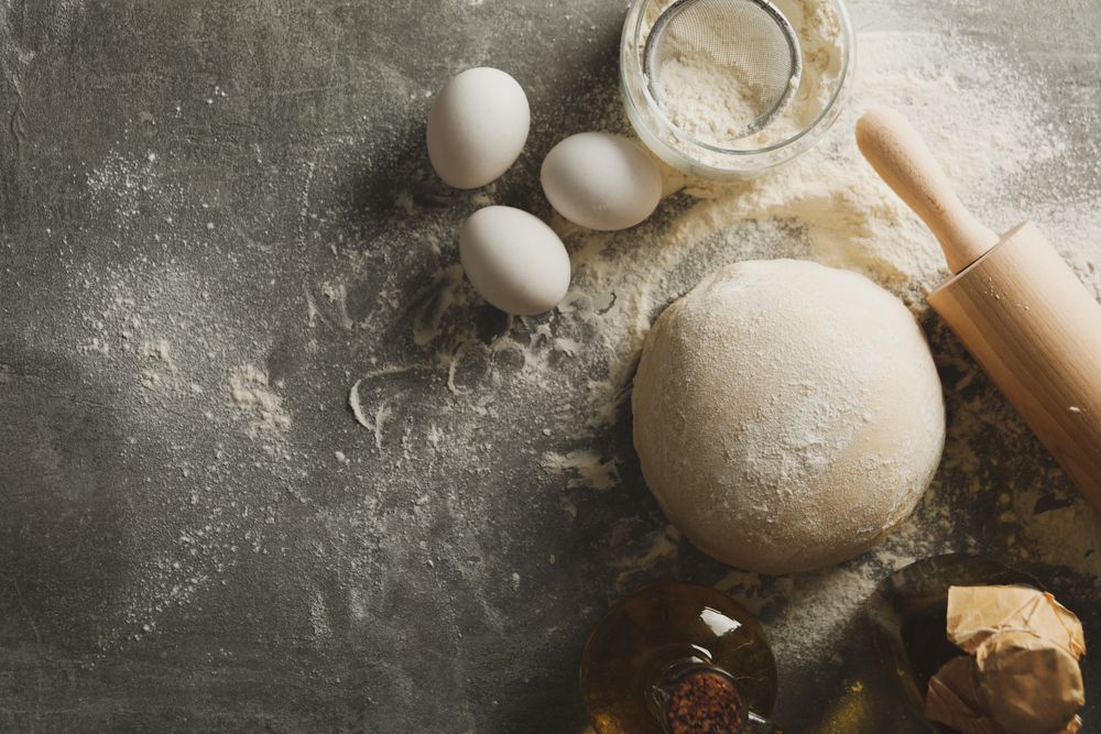 Concept for baking with dough on gray background