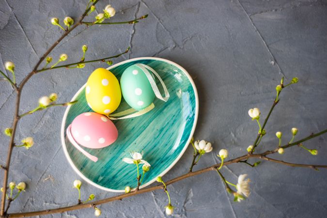 Pastel decorative eggs on egg shape plate