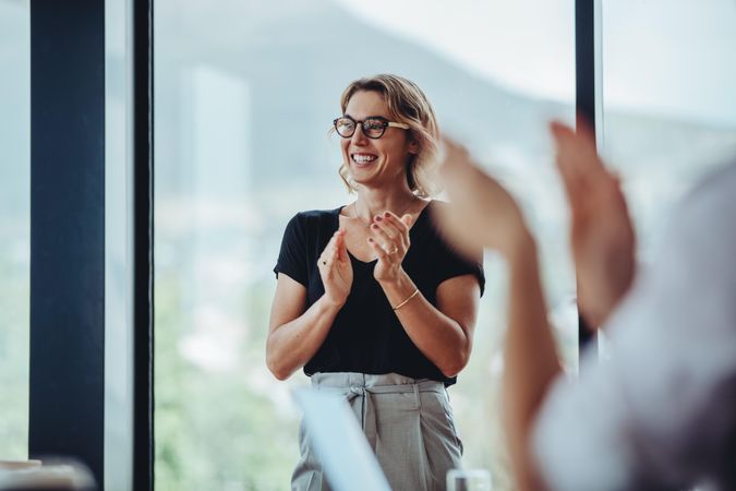 Businesswoman applauding after productive meeting