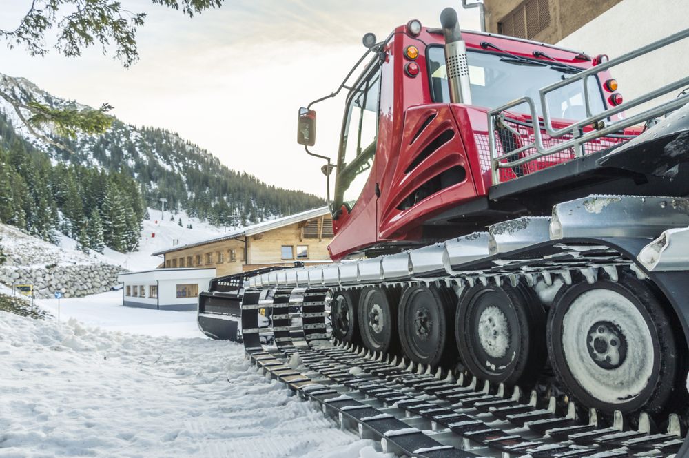 Side view of a snow groomer car