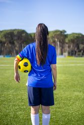 Back of female soccer player with rainbow armband