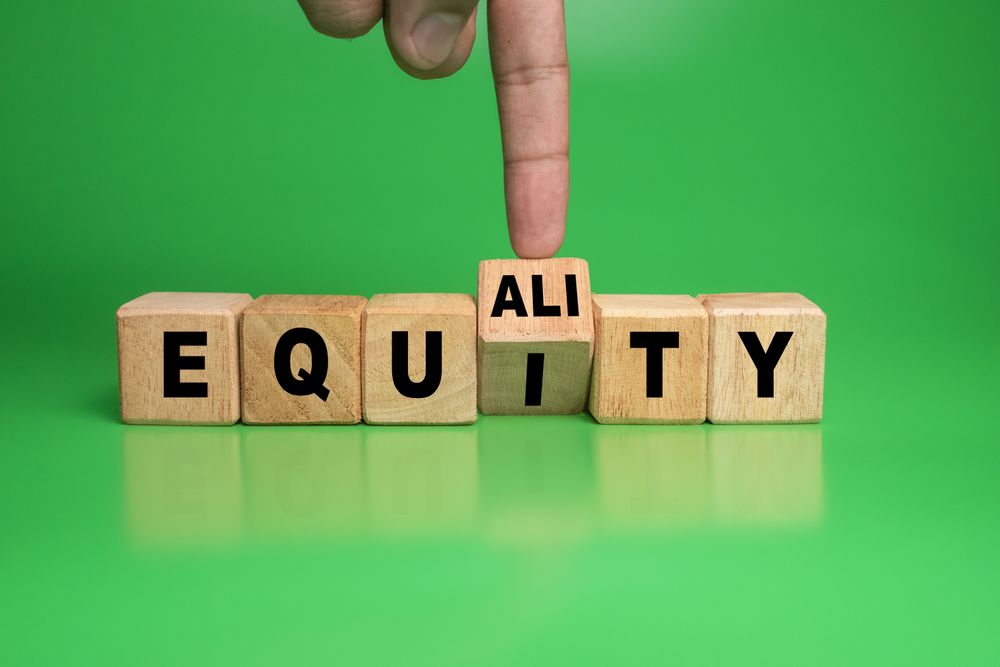 male hand turn wooden blocks with equality and equity words isolated on green background