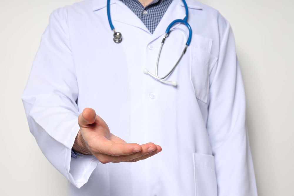A man in a doctor's coat with a stethoscope