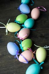 Easter card concept with pastel eggs scattered on wooden table