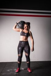 Woman lifting medicine ball in gym